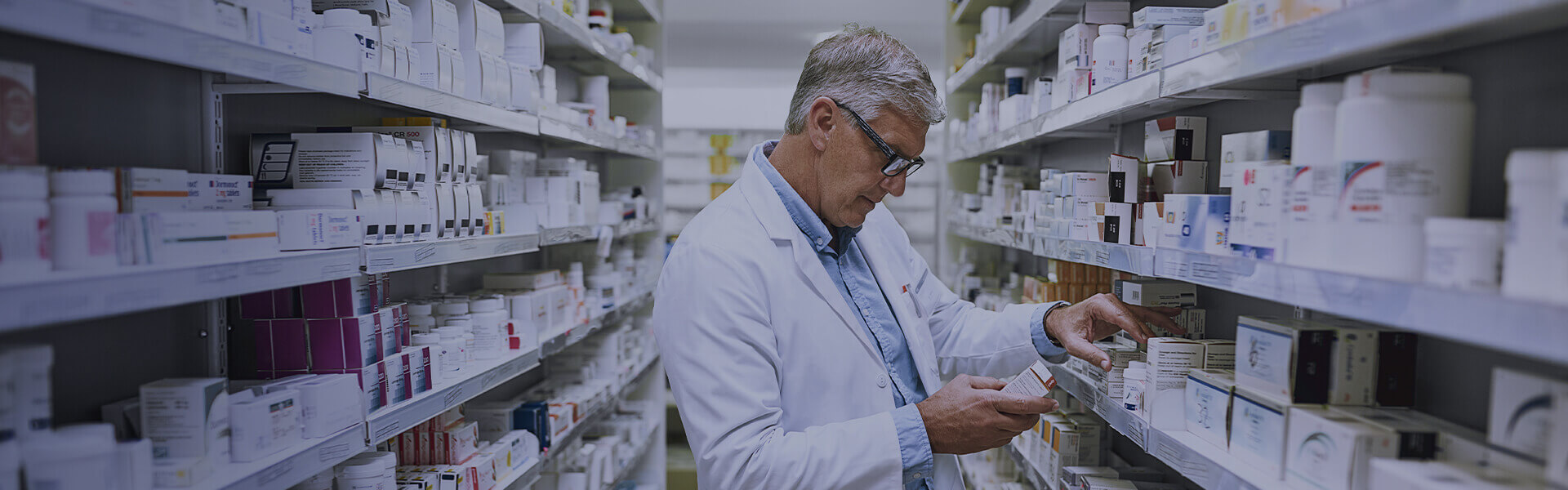 Image of pharmacist looking at a medicine label