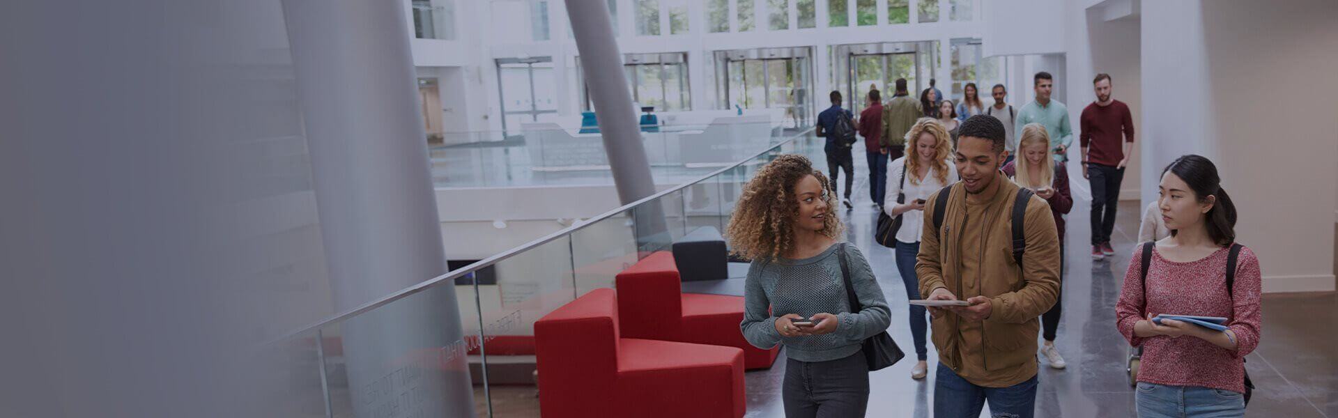 Image of students walking along a university hallway